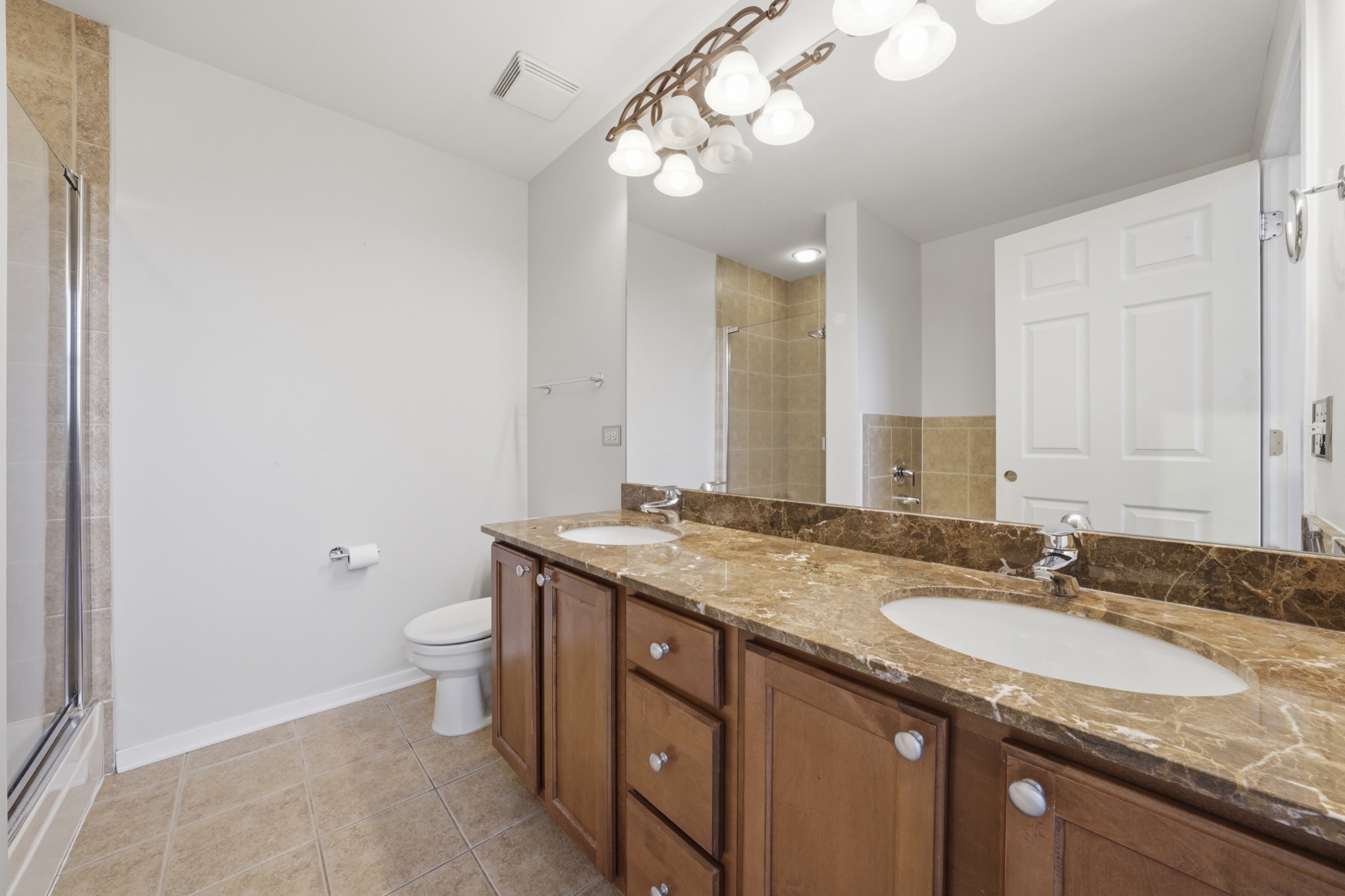 Primary bath with a double vanity and glass shower