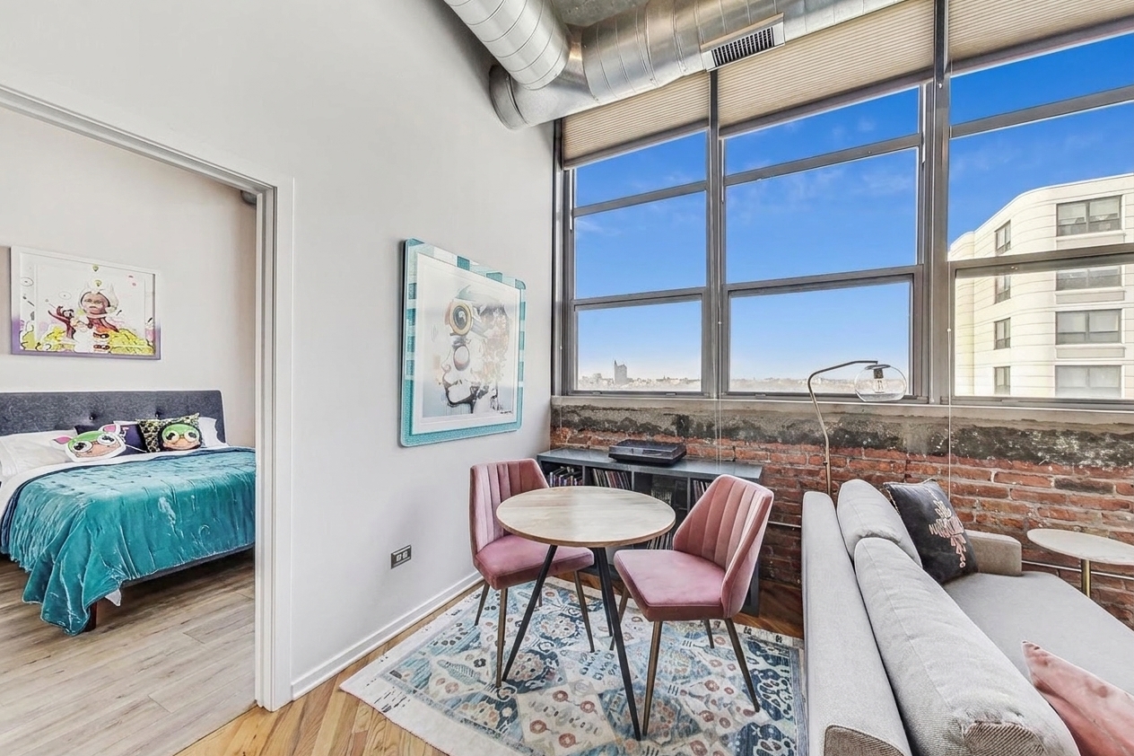 Dining corner by the window with a peek into bedroom two