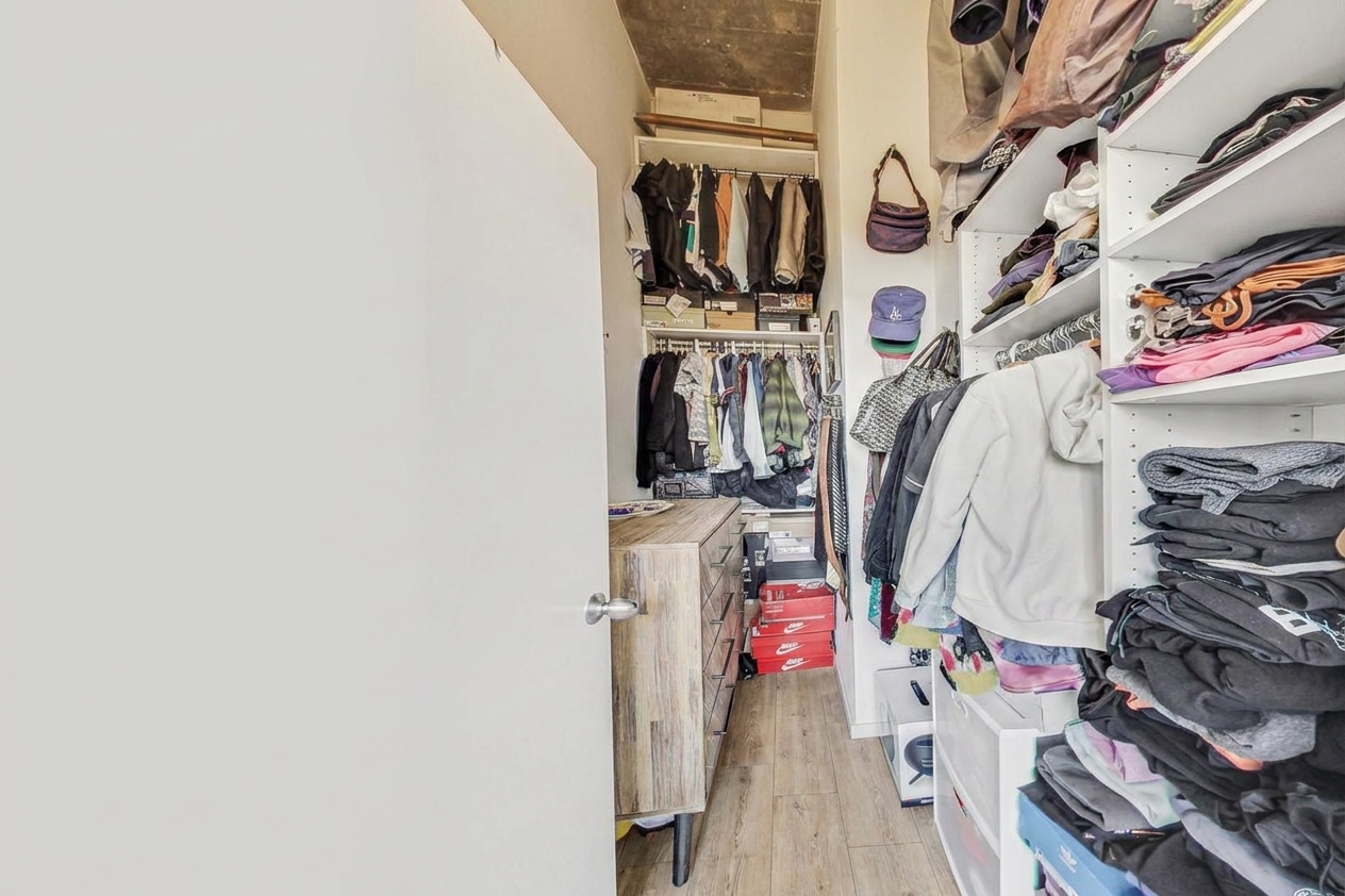 The walk in closet, shelved on both sides